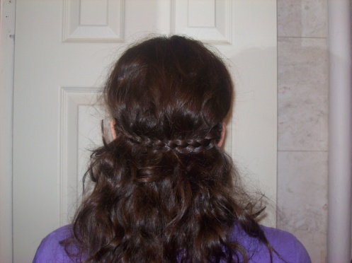 Like this! See? It serves as a barrette, almost. But, as you can see, my layers start to sneak out from under the braid. Nothing a little hairspray can't govern.